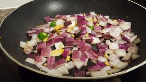 Fry the onions in methi mattar malai recipe