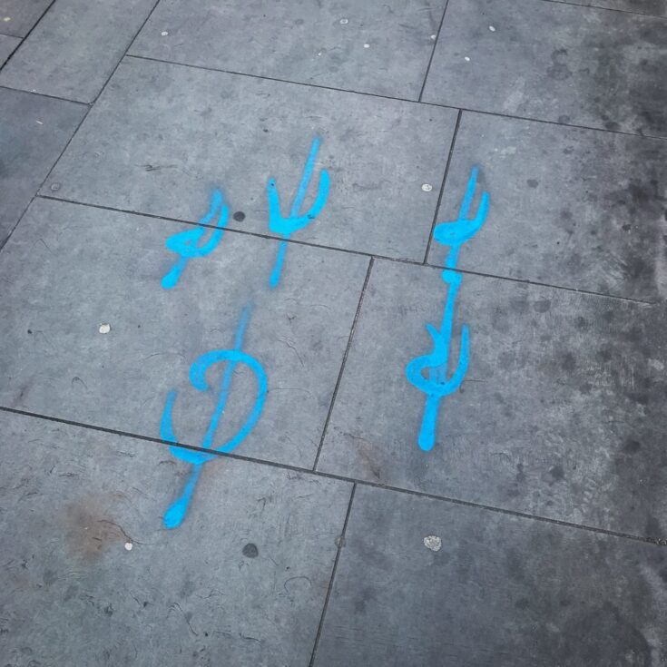 Spray-painted symbols discovered on the pavement whilst travelling. Photo by Ryan Heath.