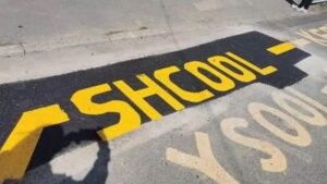 Workers spell ‘school’ wrong on painted road marking