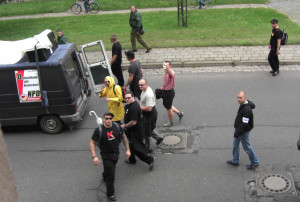 Two members of the banned Kameradschaft Hauptvolk, who worked as security guards, Daniel Kuhn, (red 'K' on black t-shirt) and Maurice Kindt (behind Kuhn, black trousers and shirt). Picture taken at neo-Nazi rally in 2007. (© apabiz)