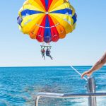 watching-two-children-parasailing-from-back-of-boat