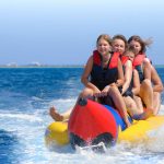 family-riding-on-banana-boat