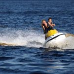 man-and-woman-riding-jet-ski