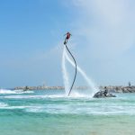 flyboarders-and-jetskiers-near-rocky-shores