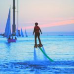 flyboarding-at-sunset-with-small-yacht