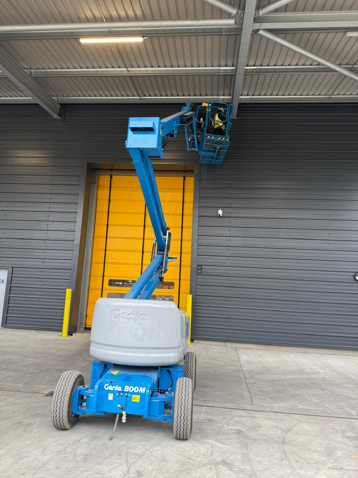 Bird netting installed under loading bay roof canopy on commercial site — Apex Pest Control bird control