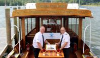 Dave Windsor and Skipper, Colin Greatorex, with Queen of the Lake's 70th birthday cake