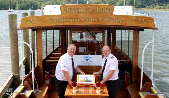 Dave Windsor and Skipper, Colin Greatorex, with Queen of the Lake's 70th birthday cake