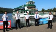 Five trainee masters of MV Swift standing in front of MV Swift