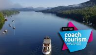 Steamer MV Swan traveling north on Lake Windermere with the Coach Tourism Awards logo.