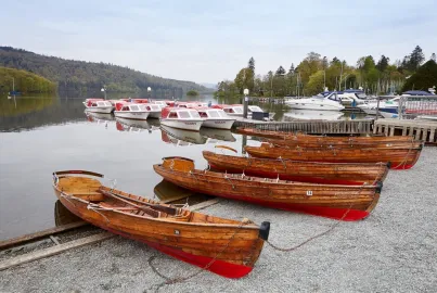 Rowing boats and electric boats on Bowness Beach - a hire point next to Bowness village centre