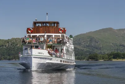 A crowd of passengers admire the view from the outer decks of MV Swan