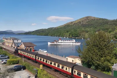 A steamer and steam train at Lakeside Pier and station.