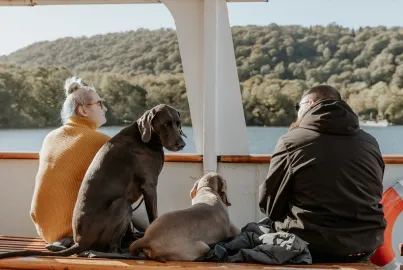 Two passengers and their dogs on the outer decks of MV Swan