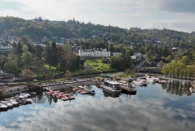 An aerial photo of Bowness Pier showing steamers, modern launches, MV Swift and self-drive boats.