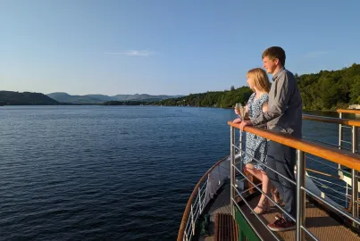 A couple on the evening cruise watch the sunset from the outer decks.
