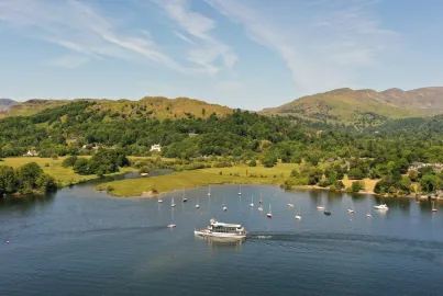 MV Swift departing Ambleside (Waterhead) Pier with the Lakeland Fells behind.