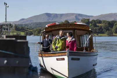 A couple in outdoor walking clothing arrive at Brockhole Pier.