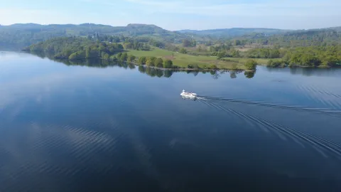One of our modern launches sailing past Wray estate