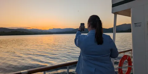 Guest enjoying the sunset view onboard