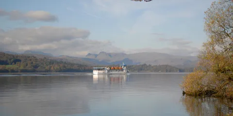 A modern launch cruising towards Waterhead