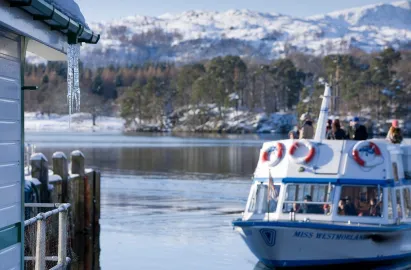 A launch leaving a frosty Ambleside (Waterhead) Pier