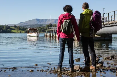 Two walkers waiting for the boat at Brockhole Pier