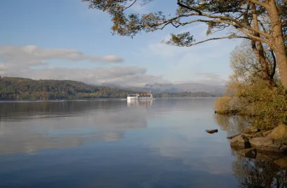 A modern launch sailing north on Windermere