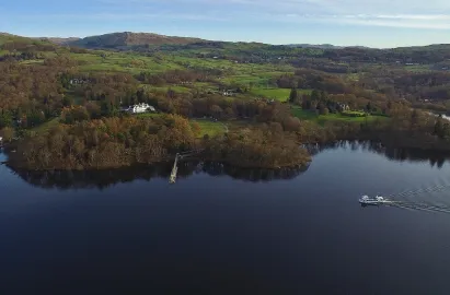 A modern launch approaching Brockhole Pier
