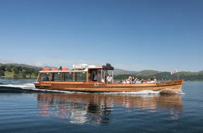 Traditional wooden launch travelling from Brockhole