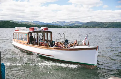 A traditional wooden launch on the green cruise