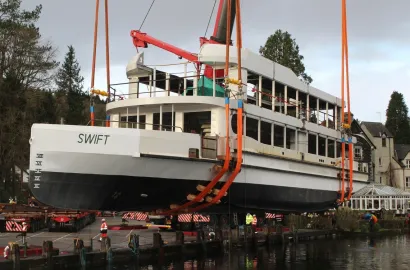 The shell of MV Swift being lowered into Lake Windermere for the 1st time. by crane