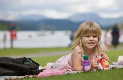 A girl enjotying a picnic on Fell Foot lawn