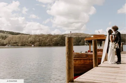 Wedding couple and traditional launch in the background