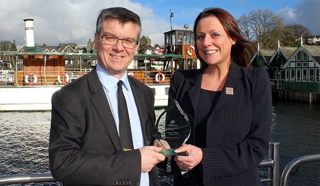 Nigel Wilkinson (Managing Director) and Jen Cormack (Sales & Marketing Director) with the award at Bowness Pier