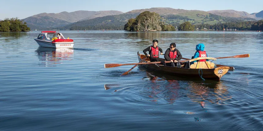 A row boat and a hired motor boat on Lake Windermere