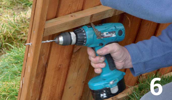 While the paint is drying drill four evenly spaced pilot holes through the side bars on both sides of each fence panel