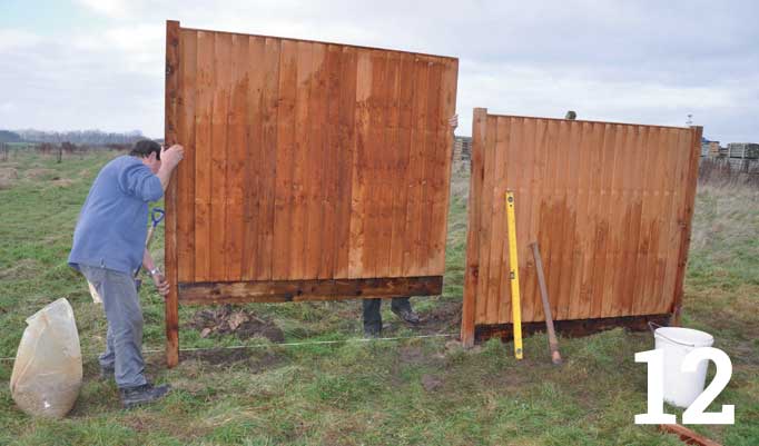 With the first panel secure, fix a post to one edge of the next fence panel