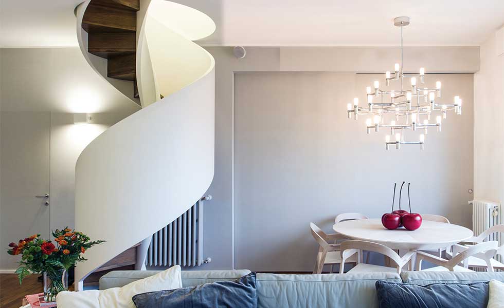 Contemporary spiral staircase with dramatic chandelier