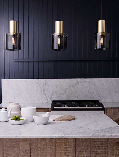 Kitchen island with marble and three pendant lights