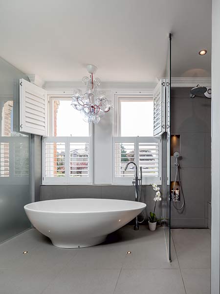 Bathroom with egg shaped bath and grey walls