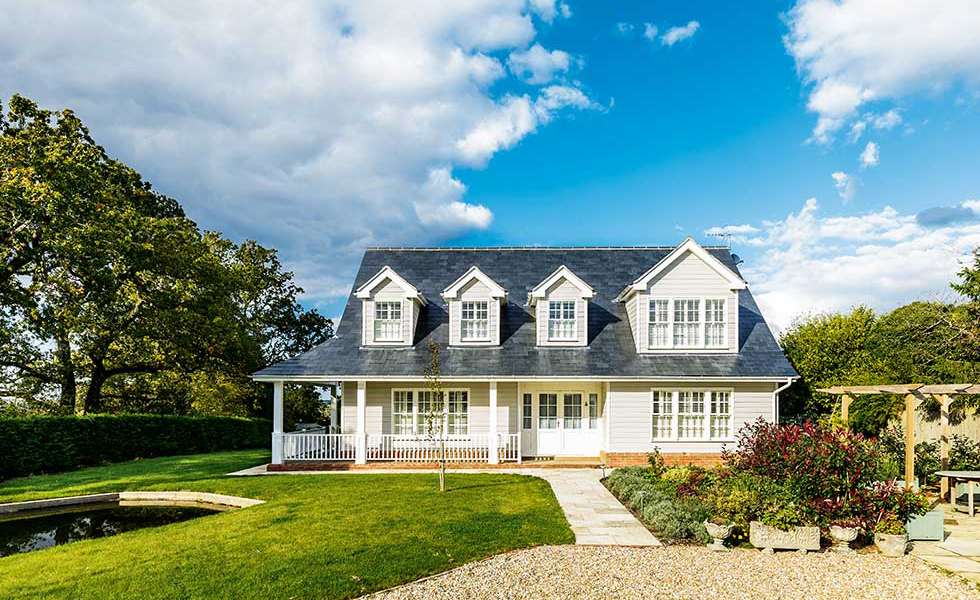american style house with dormer windows