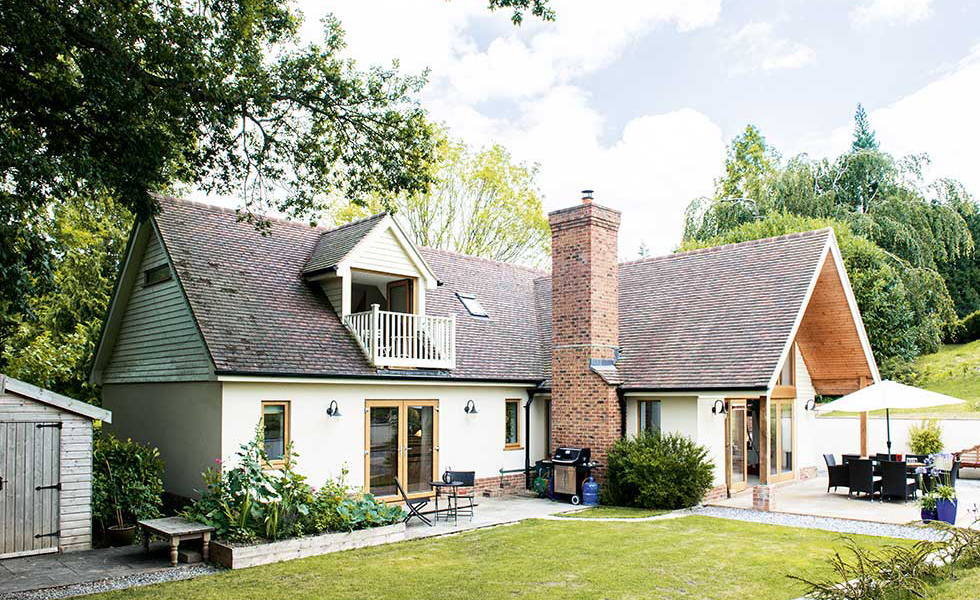 cottage style house with dormer window balcony