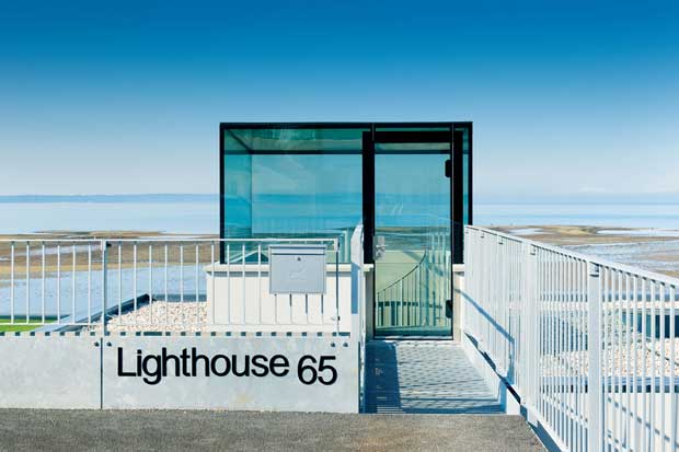 A glass box at street level marks the entrance to the house