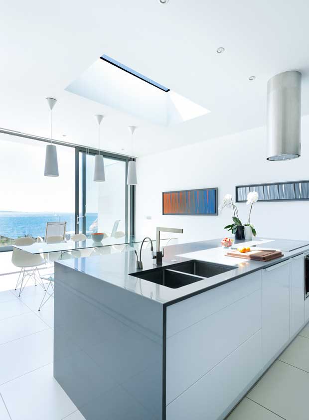 The kitchen features a large island with induction hobs
