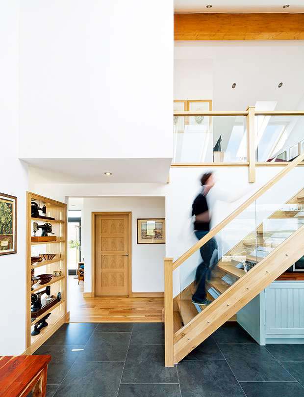 The open flight staircase in the double height kitchen