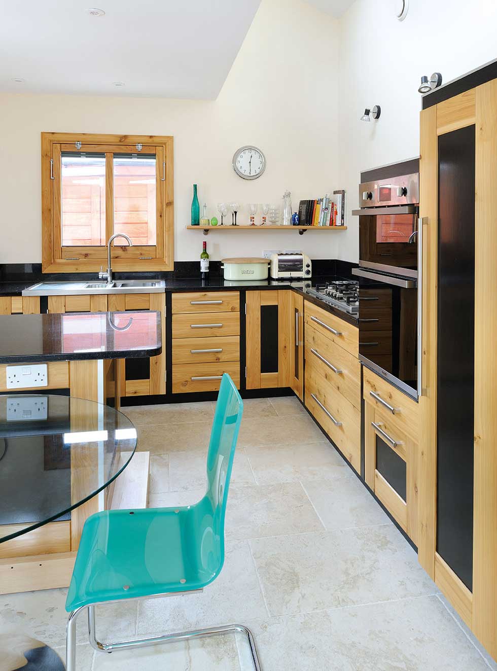 The kitchen with wood and black matt finish units