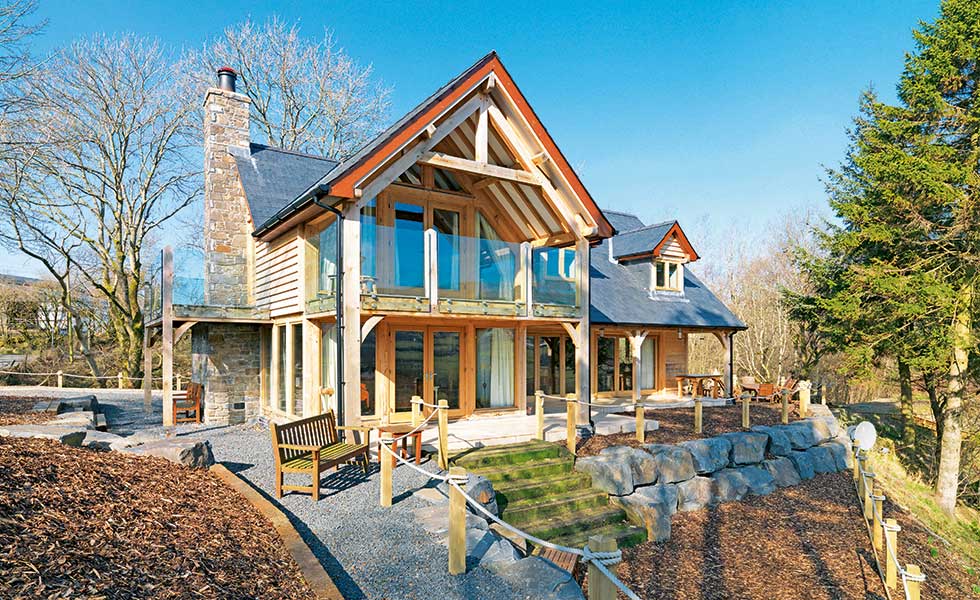 welsh oak frame home with balcony and seating area