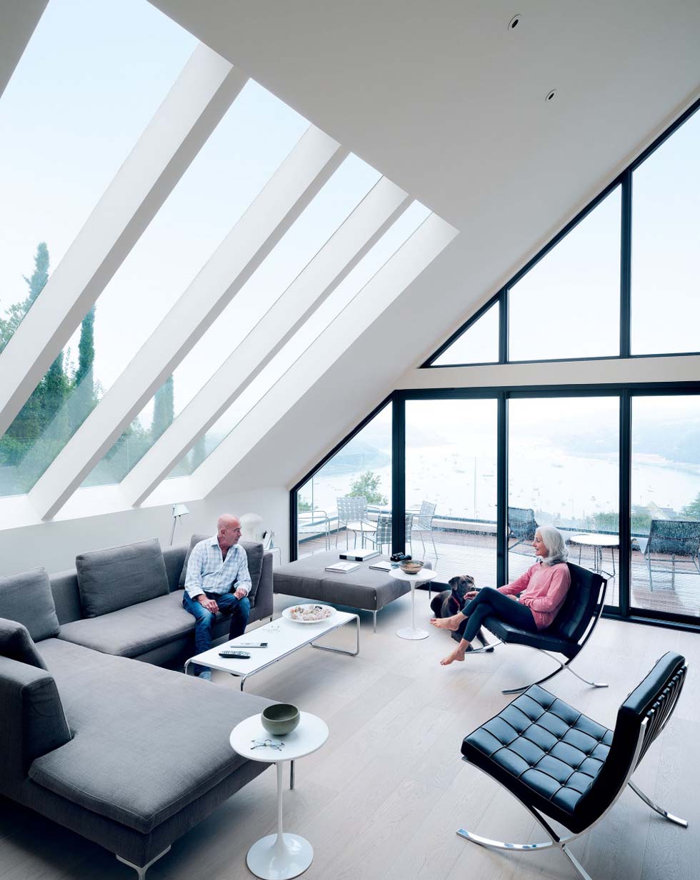 Fixed glazing and sliding doors enable the couple to enjoy estuary views