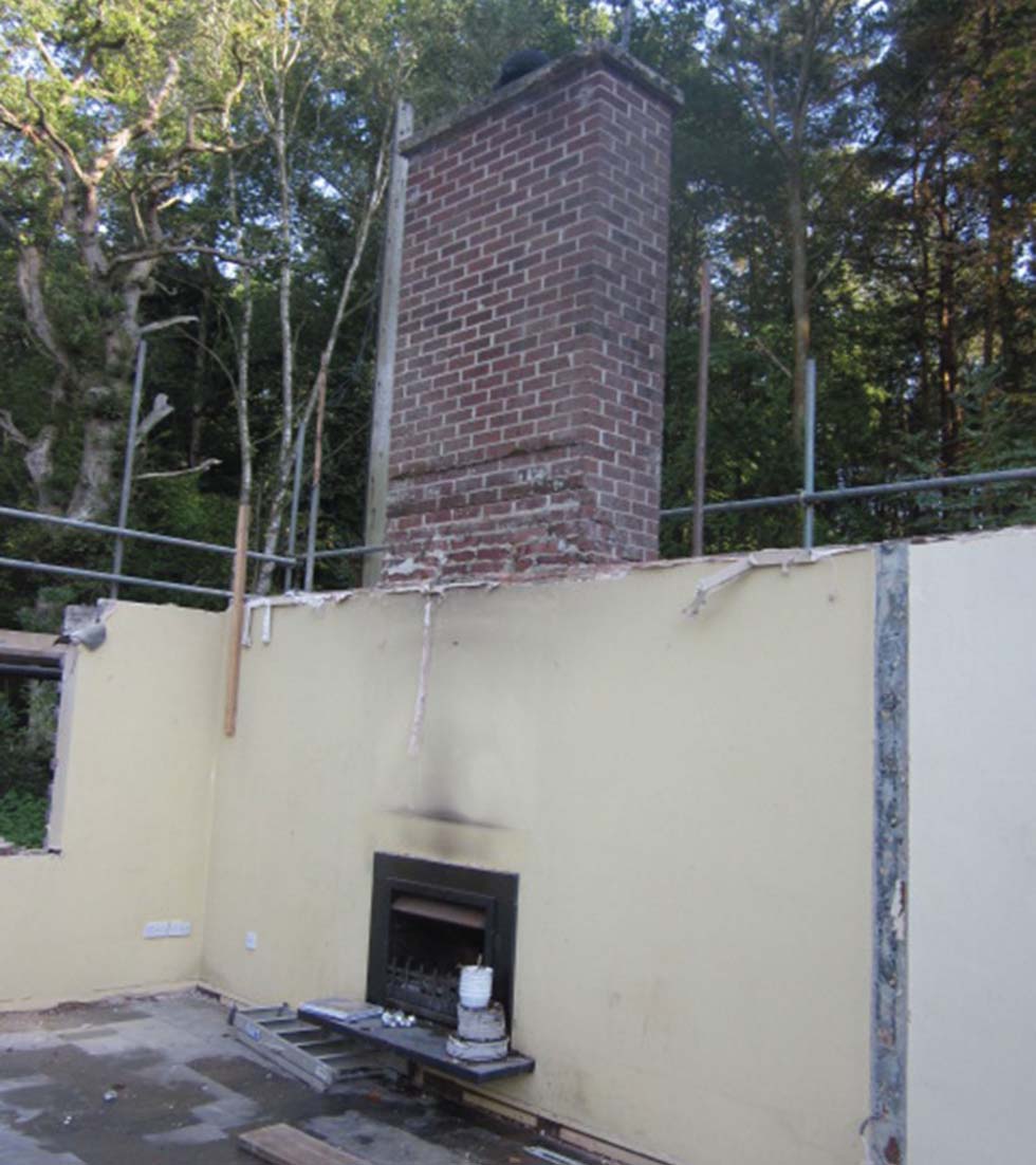 The chimney breast remains after the roof is removed